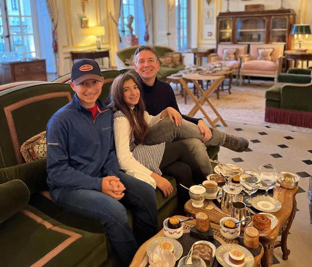 A family enjoying tea time at Hotel Airlelles near Versailles. 