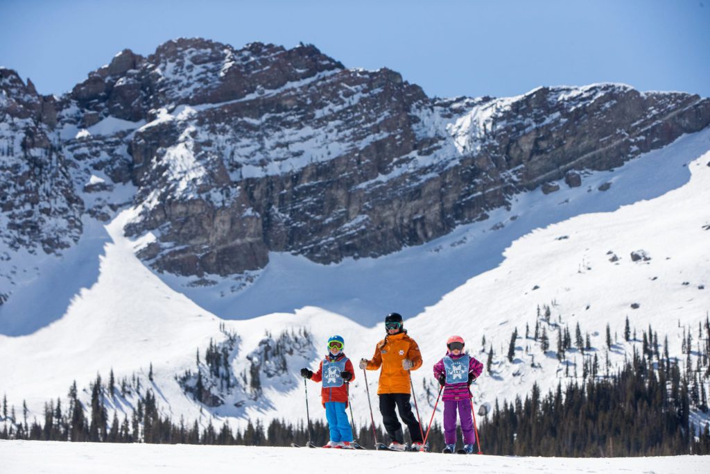 A picture of a family skiing at Alta Ski Resort, one of the best ski resorts in Utah for families.