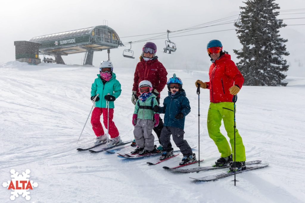 A family of four skiing at the Alta Ski Resort in Utah.