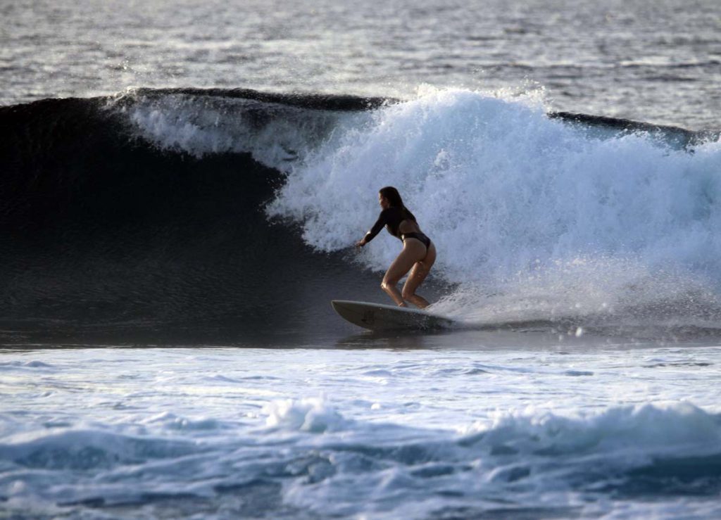 A woman surfing in the ocean.