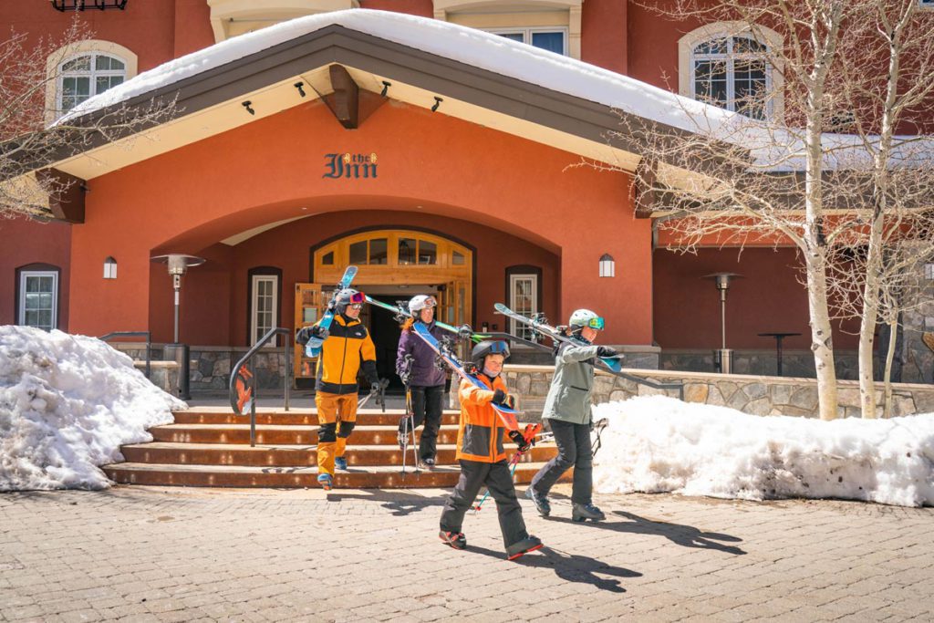 A family holding their skis at Solitude Ski Resort in Utah.
