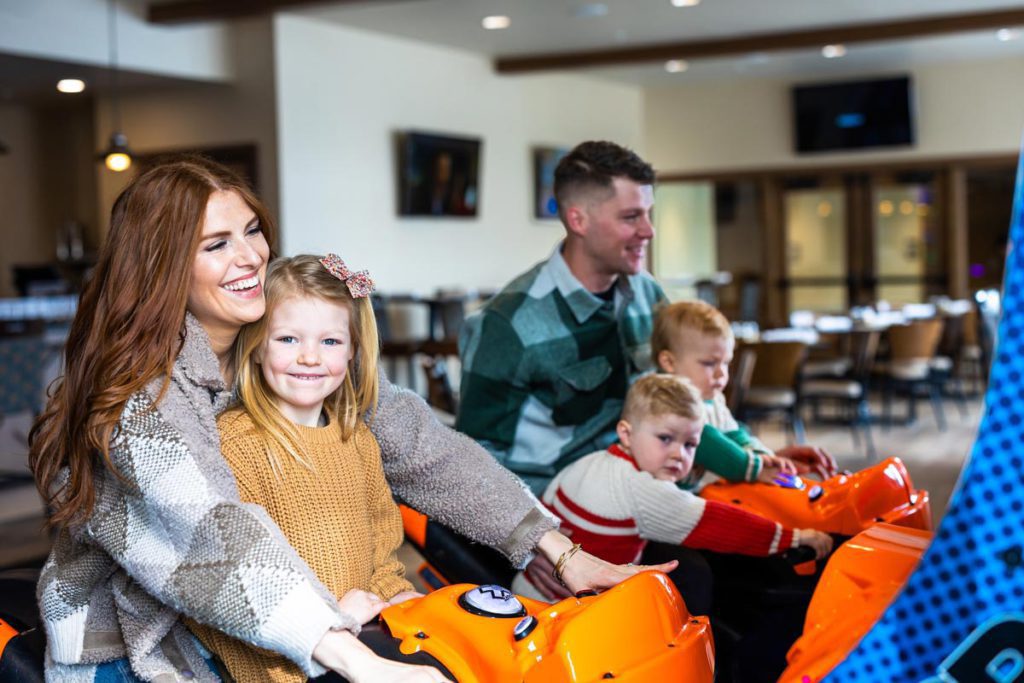 A family playing in the game room at Stein Eriksen Lodge in Deer Valley, Utah