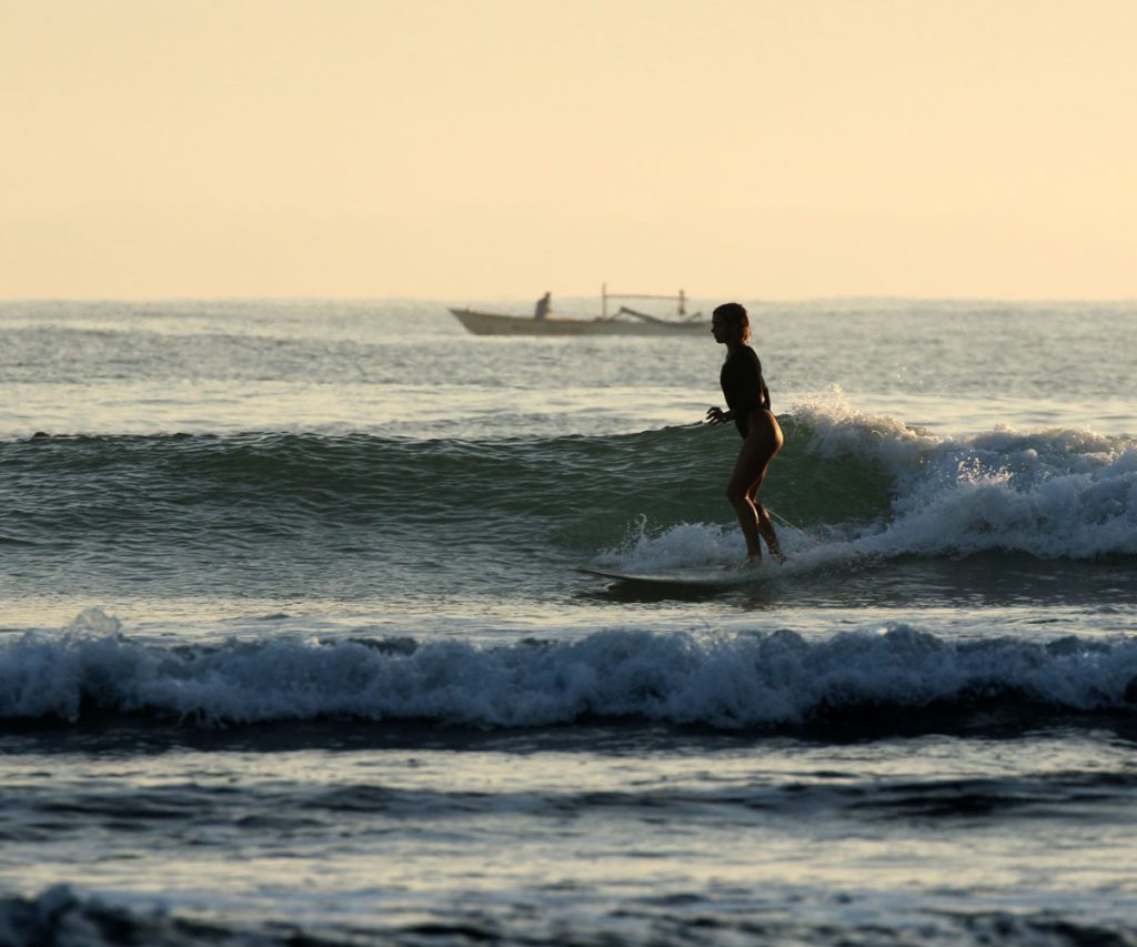 A woman surfing in the ocean.