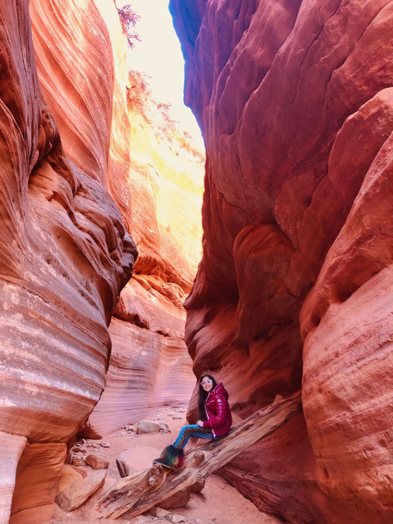A young girl in Peekaboo Slot Canyon, Kanab. It's one of the best bucket list experiences in the United States for your family.