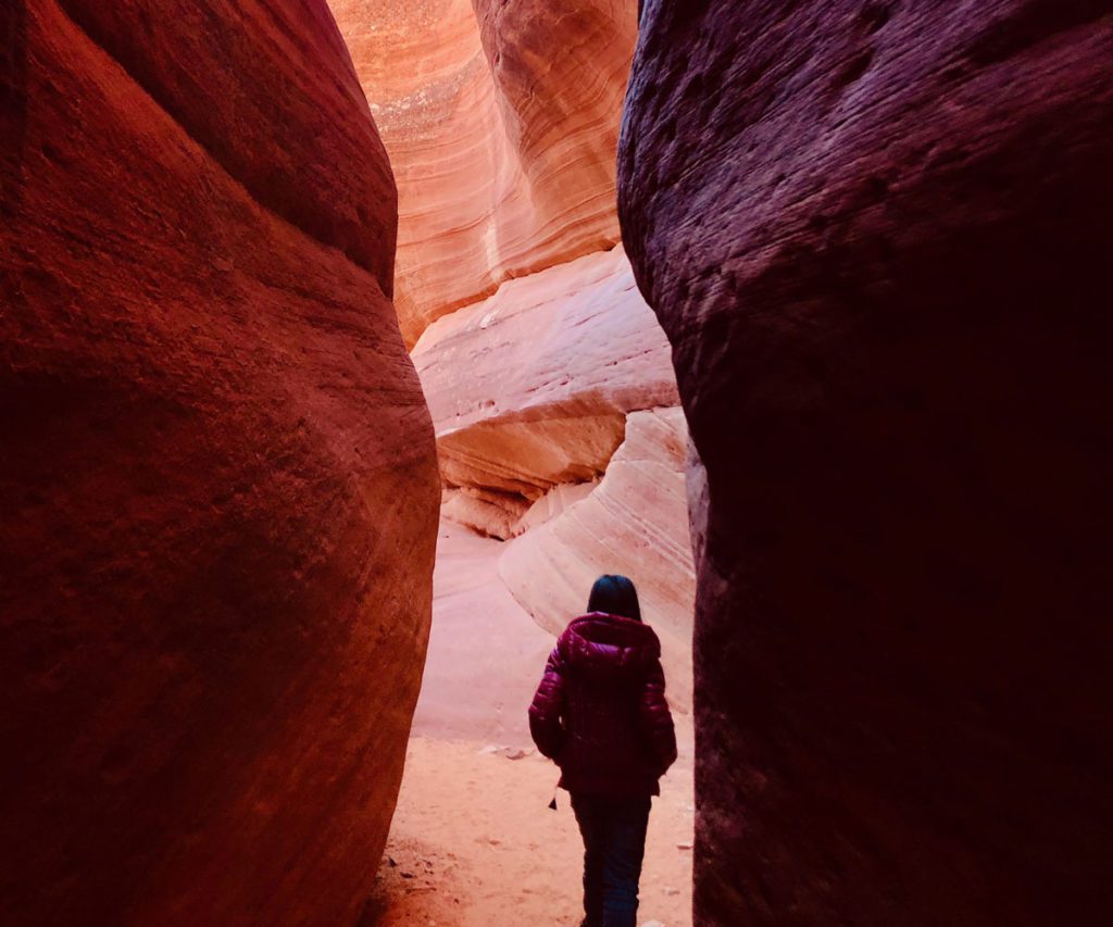 A young girl in a slot canyon near Kanab, Utah, one of the best weekend getaways from Salt Lake City for families. 