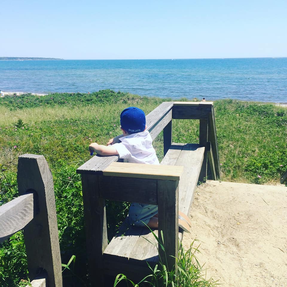 A young boy overlooking the landscape in Hyannis, one of the best places to stay in Cape Cod with kids.