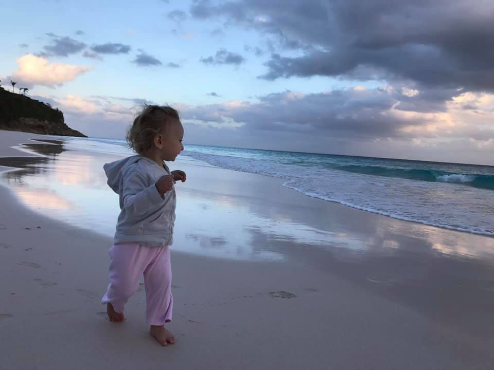 A child walking along the beach in Bermuda. 