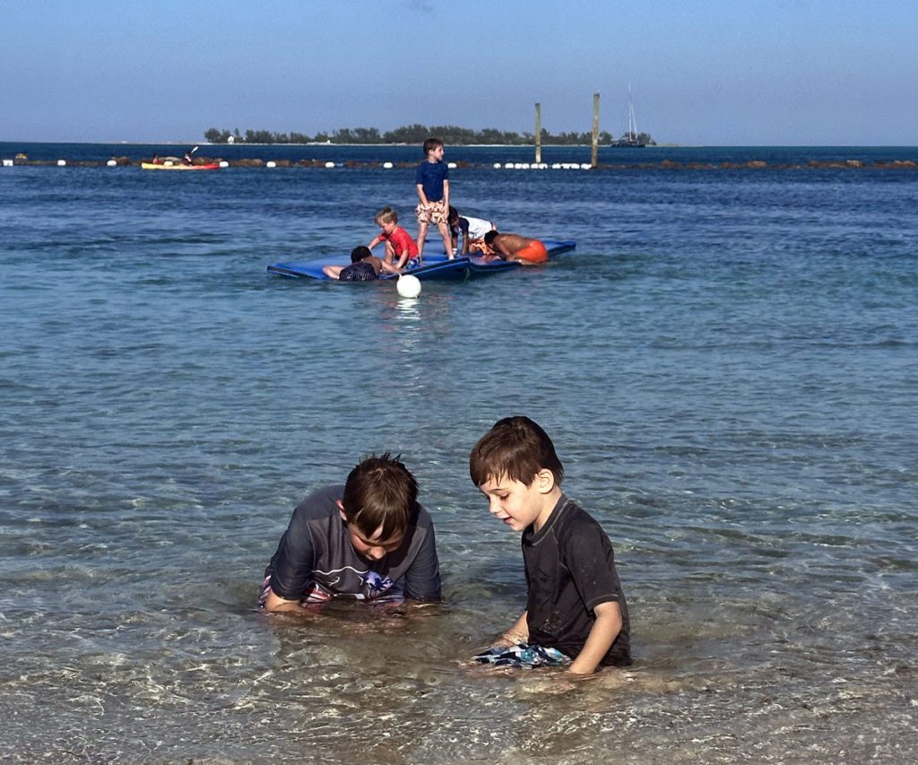 Two boys playing in the water in the Bahamas. 