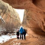 A father standing with his two kids in Capitol Reef National Park.