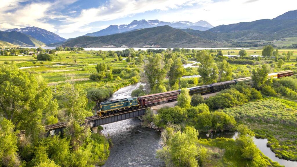 The Herber Valley Railroad riding through the green landscape in Herber Valley, Utah, one of the best weekend getaways from Salt Lake City for families. 