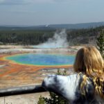 A young girl overlooking the Grand Prismatic Spring in Yellowstone National Park.