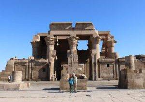 Two kids stand together in front of ancient ruins in Luxor, Egypt.